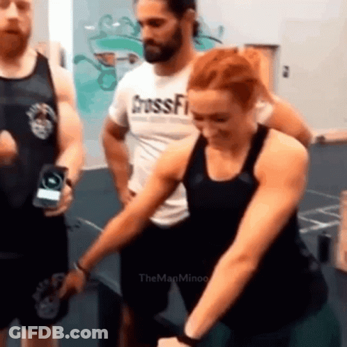 Woman Sitting On Green Ball With Man Behind Her GIF