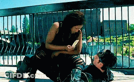 Woman Sitting On Man Lying On Ground GIF