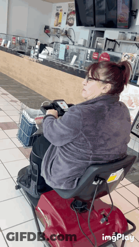 Woman Sitting On Mobility Scooter In Restaurant GIF