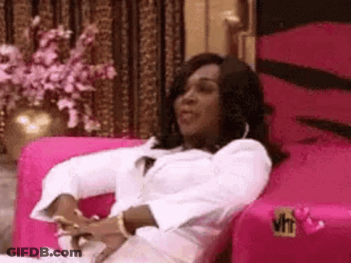 Woman Sitting On Pink Couch GIF