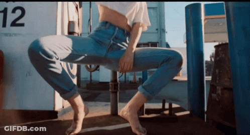 Woman Sitting On Pole With Number 12 GIF