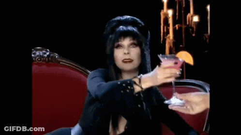 Woman Sitting On Red Couch Holding Martini GIF