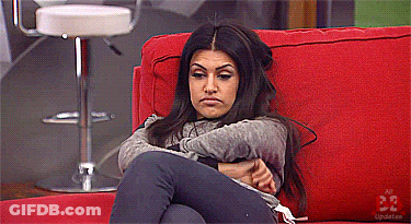 Woman Sitting On Red Couch With Arms Crossed Number 33 GIF