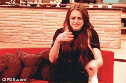 Woman Sitting On Red Couch With Brick Wall GIF