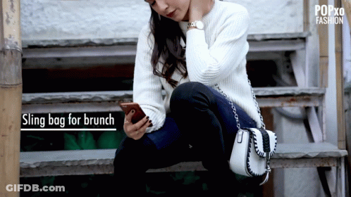 Woman Sitting On Stairs Looking At Phone Sling Bag For Brunch GIF