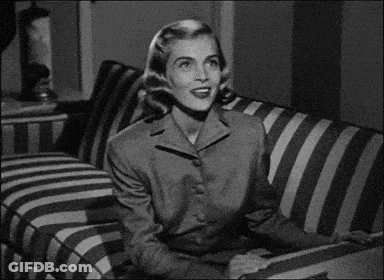 Woman Sitting On Striped Couch Looking GIF