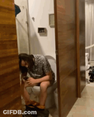 Woman Sitting On Toilet With Legs Crossed GIF