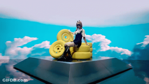 Woman Sitting On Yellow Wheels GIF