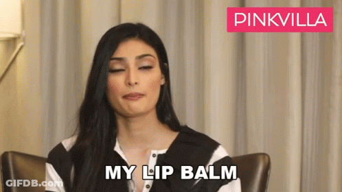 Woman Sitting With Eyes Closed And Lip Balm GIF