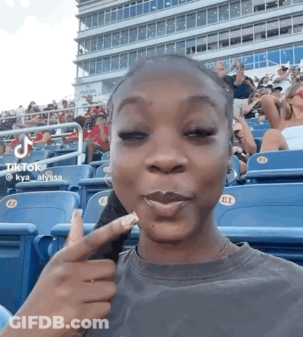 Woman Sitting With Eyes Closed And Making Face GIF