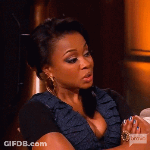 Woman Sitting With Folded Hands And Bravo Logo GIF