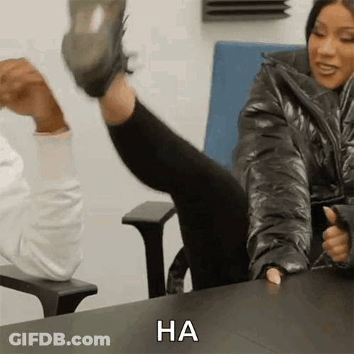 Woman Sitting With Leg Up Saying Ha GIF