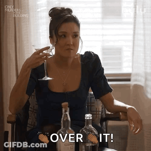 Woman Sitting With Martini And Bottles GIF