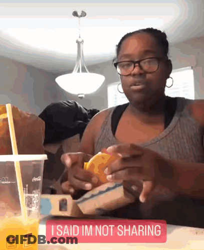 Woman Sitting With Orange Juice And I Said Im Not Sharing Sign GIF