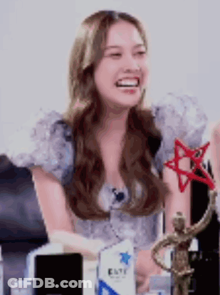Woman Sitting With Statue And Trophy GIF