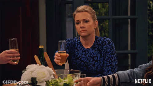 Woman Sitting With Wine And Netflix Logo GIF