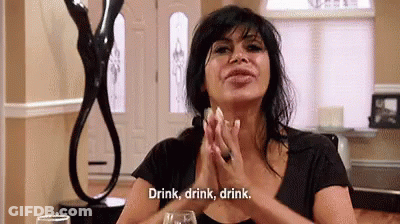 Woman Sitting With Wine Saying Drink Drink Drink GIF