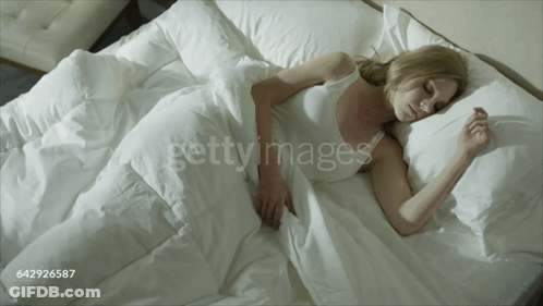 Woman Sleeping In Bed With White Sheets GIF