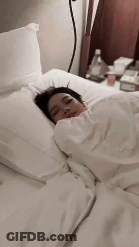 Woman Sleeping In Bed With White Sheets GIF