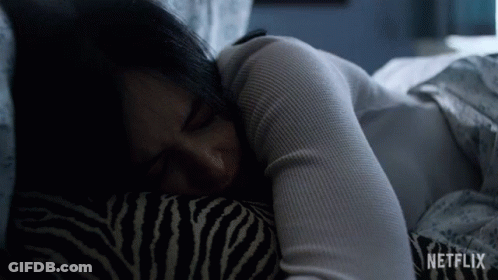 Woman Sleeping In Bed With Zebra Pillow And Netflix Logo GIF