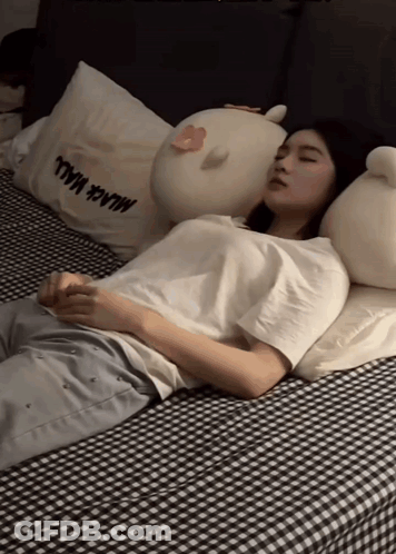 Woman Sleeping On Bed With Milk Mall Pillow GIF