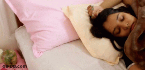 Woman Sleeping On Bed With Pink And White Pillows GIF
