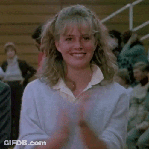 Woman Smiling And Clapping In Front Of Crowd GIF