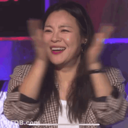 Woman Smiling And Clapping In Plaid Jacket GIF