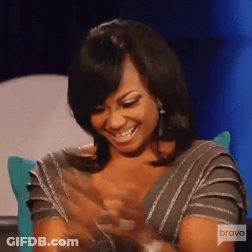 Woman Smiling And Clapping On Couch GIF