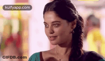 Woman Smiling At Camera Wearing Necklace And Earrings GIF
