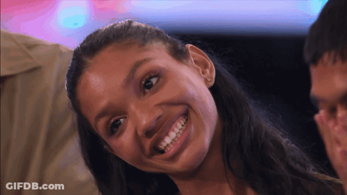 Woman Smiling At Camera With Man Behind GIF