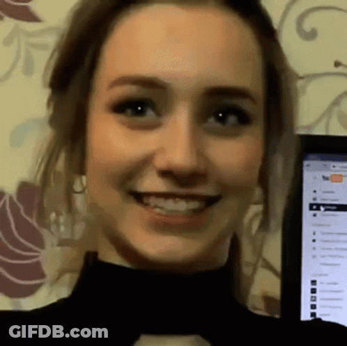 Woman Smiling At Computer Screen With YouTube GIF