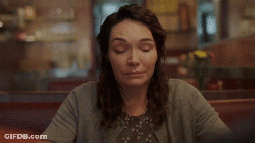 Woman Smiling At Diner Table GIF