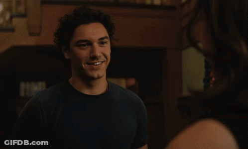 Woman Smiling At Man Wearing Necklace GIF