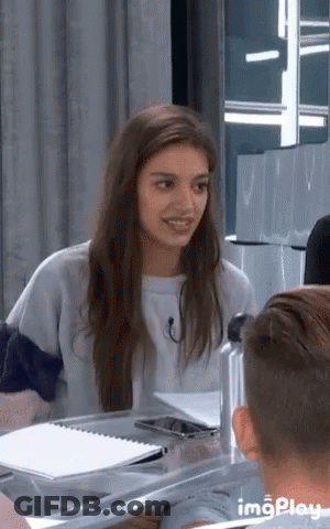 Woman Smiling At Table With Man And Water Bottle GIF