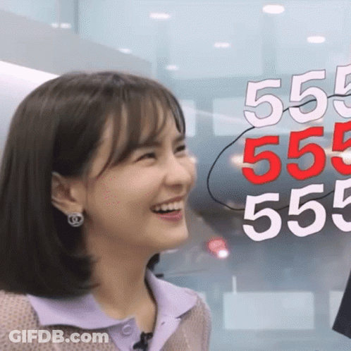 Woman Smiling Beside Sign 555 555 555 555 GIF