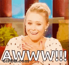 Woman Smiling Hands To Chest Saying Aww GIF