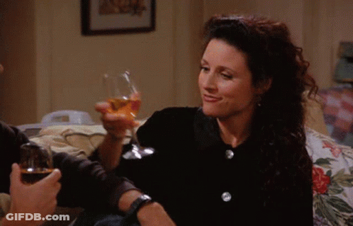 Woman Smiling Holding Glass Of Wine GIF