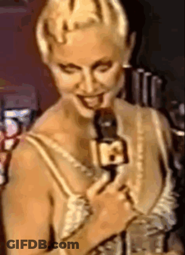 Woman Smiling Holding Microphone With Number 18 GIF