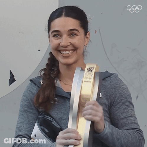 Woman Smiling Holding Olympics Trophy GIF