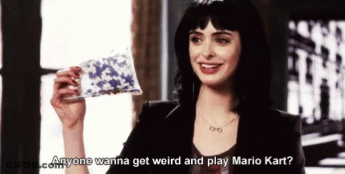 Woman Smiling Holding Paper Saying Anyone Wanna Get Weird And Play Mario Kart GIF