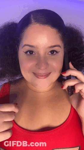 Woman Smiling Holding Phone With Red Nails GIF