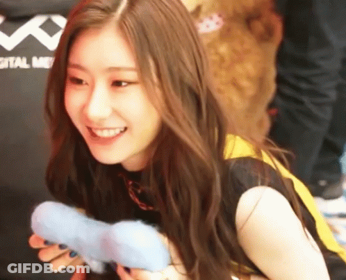 Woman Smiling Holding Toy In Front Of Digital Me Shirt GIF