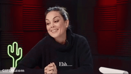Woman Smiling In Black Sweater Near Neon Cactus GIF
