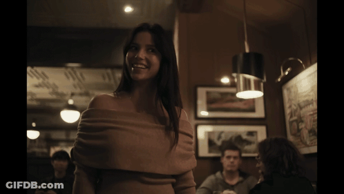Woman Smiling In Dark Room GIF