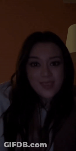 Woman Smiling In Dark Room GIF