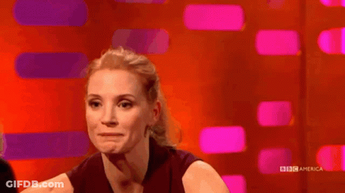 Woman Smiling In Front Of BBC America Screen GIF
