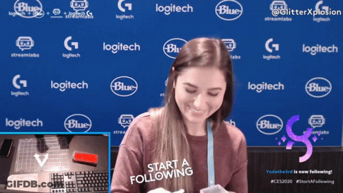 Woman Smiling In Front Of Blue Background With Logitech Logos GIF