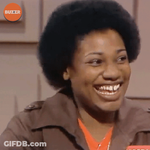Woman Smiling In Front Of Buzzr Logo GIF