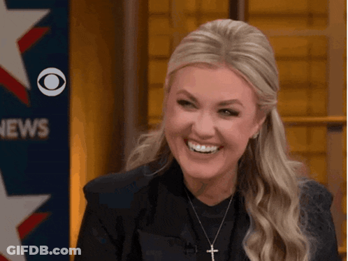 Woman Smiling In Front Of CBS News Sign GIF
